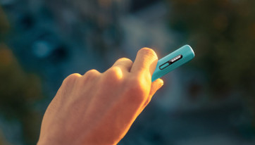 Podgrzewacz tytoniu IQOS ILUMA i ONE w kolorze Breeze Blue w dłoni